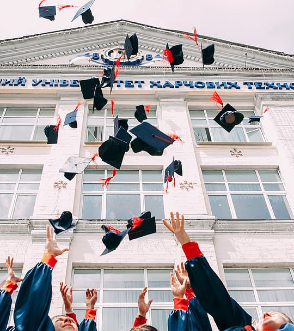 group-of-fresh-graduates-students-throwing-their-academic-hat-in-the-air